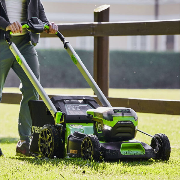 Greenworks 60V cordless lawnmower in use close up side view
