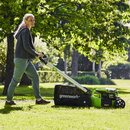 Greenworks 60V cordless lawnmower in use side view